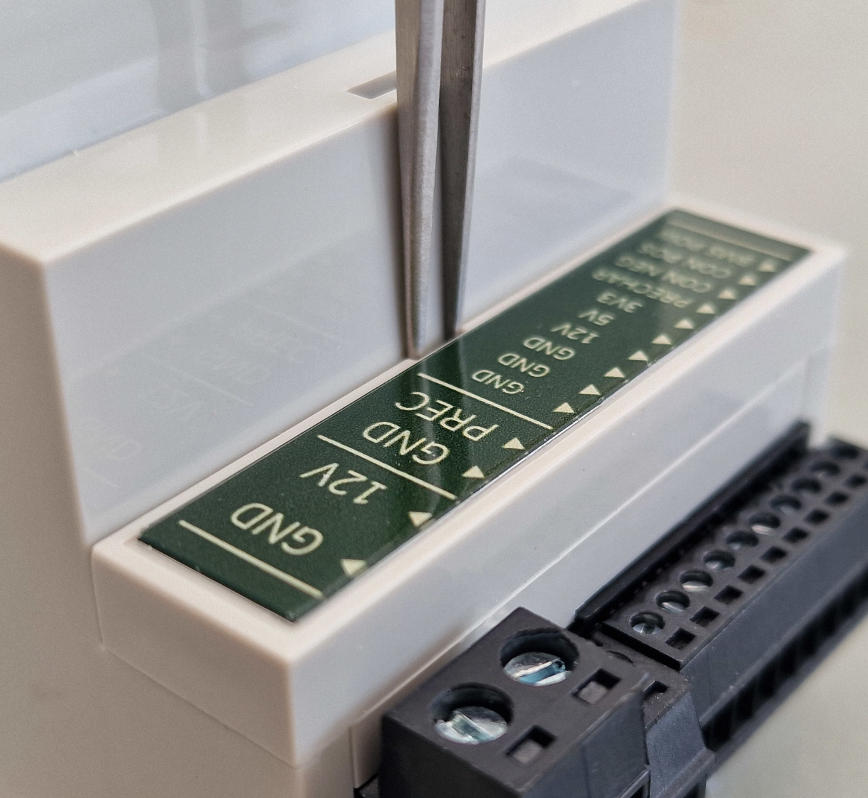 Close-up of a electronic component with labeled pins on a white background