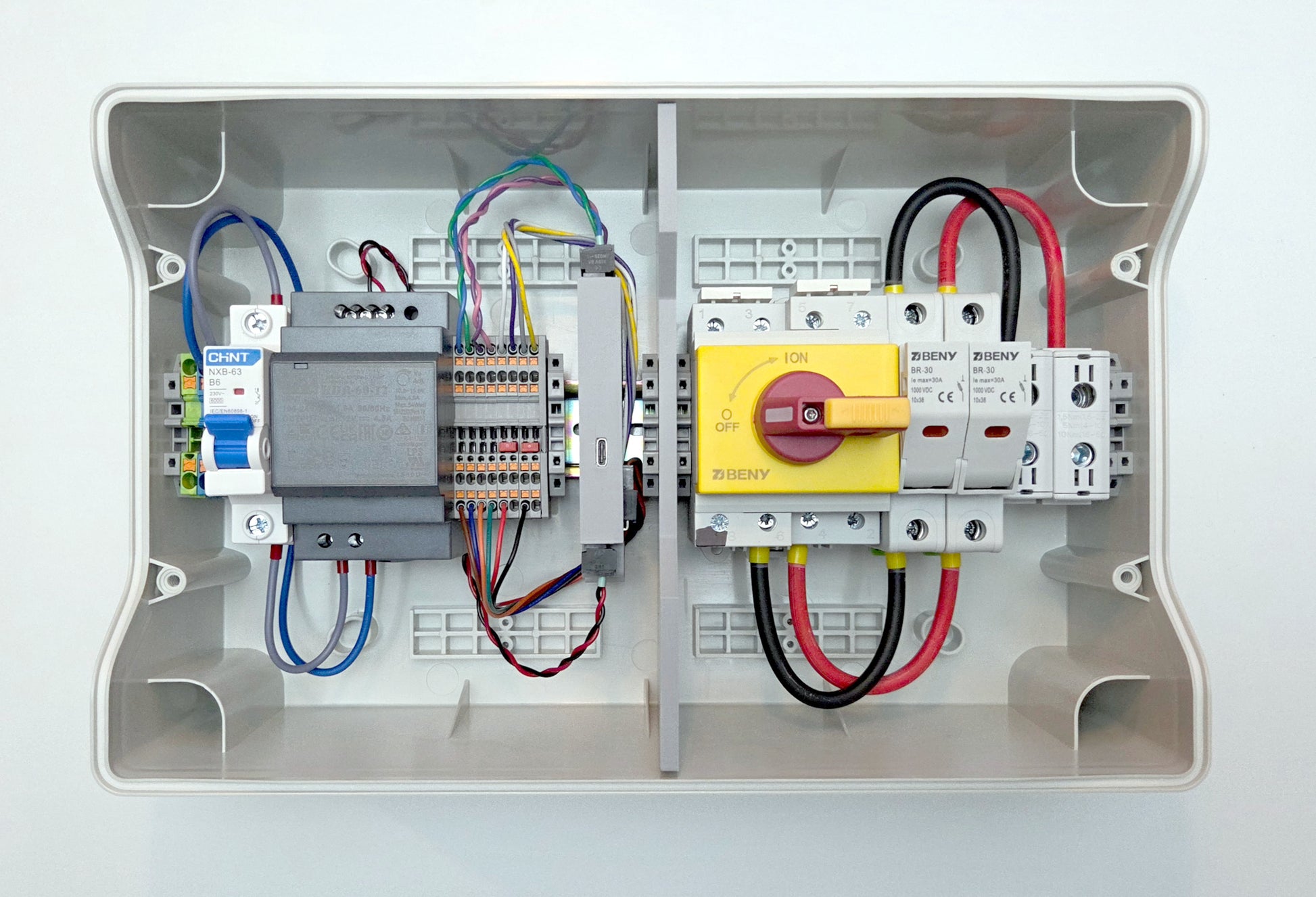 Electrical panel with wiring and components on a white background