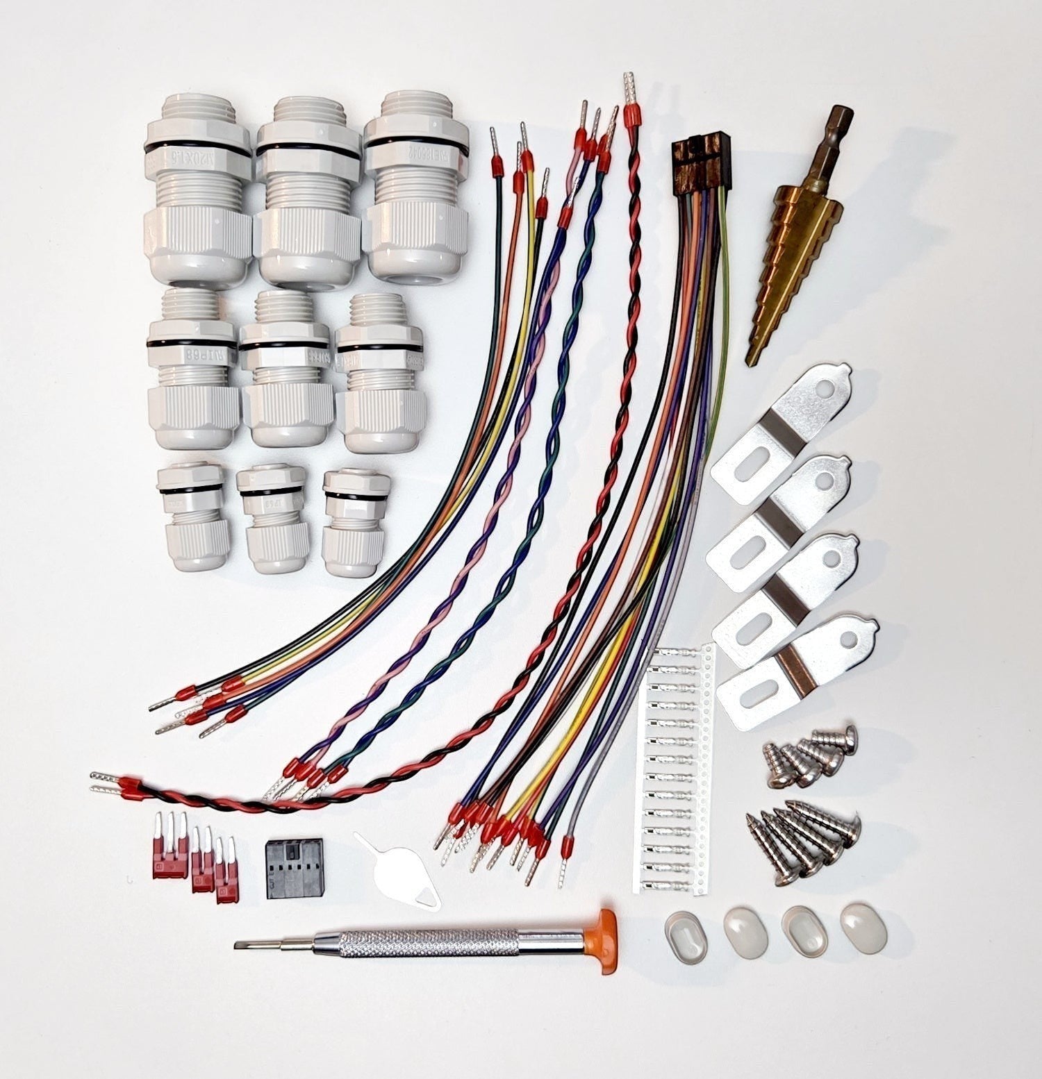 Redispose Stark Box Basic starter kit with various cables, connectors, cable glands, screws, and a step drill bit.