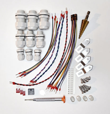 Redispose Stark Box Basic DIY kit includes cable glands, wires, mounting brackets, screws, and a step drill bit.