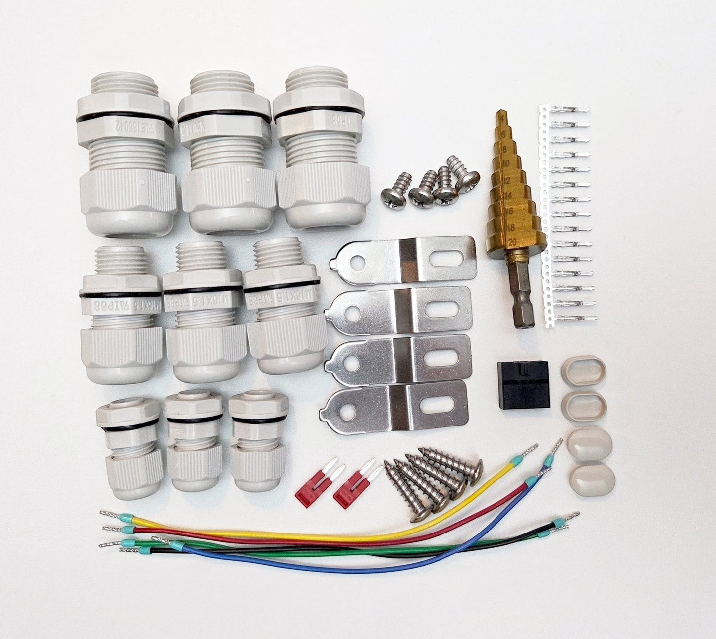 Redispose Stark Box Basic kit includes cable glands, screws, metal brackets, step drill bit, wire connectors, and fuses for electrical projects.