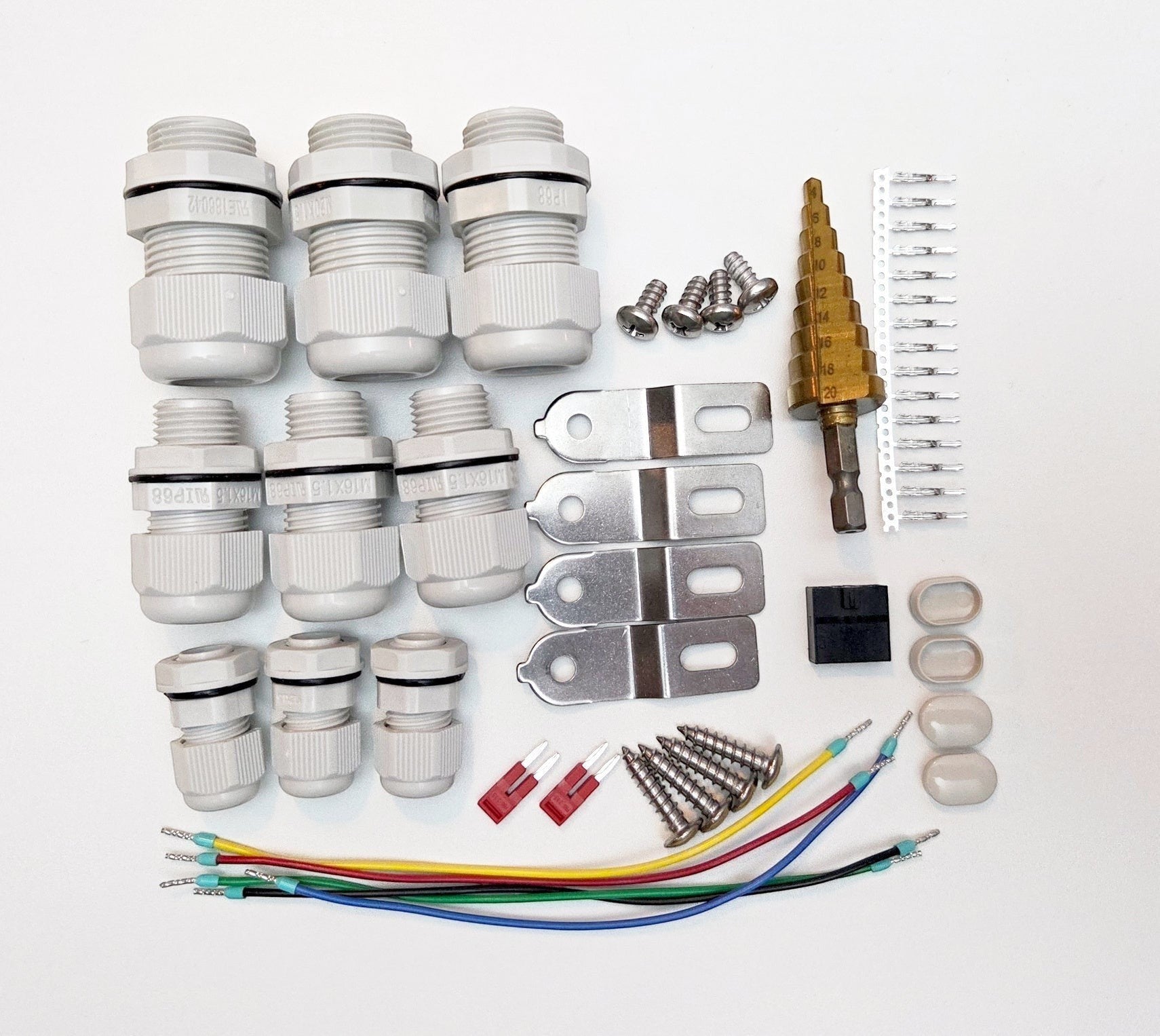 Redispose Stark Box Basic kit includes cable glands, screws, metal brackets, step drill bit, wire connectors, and fuses for electrical projects.