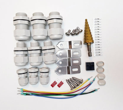 Redispose Stark Box Basic kit includes cable glands, screws, metal brackets, step drill bit, wire connectors, and fuses for electrical projects.