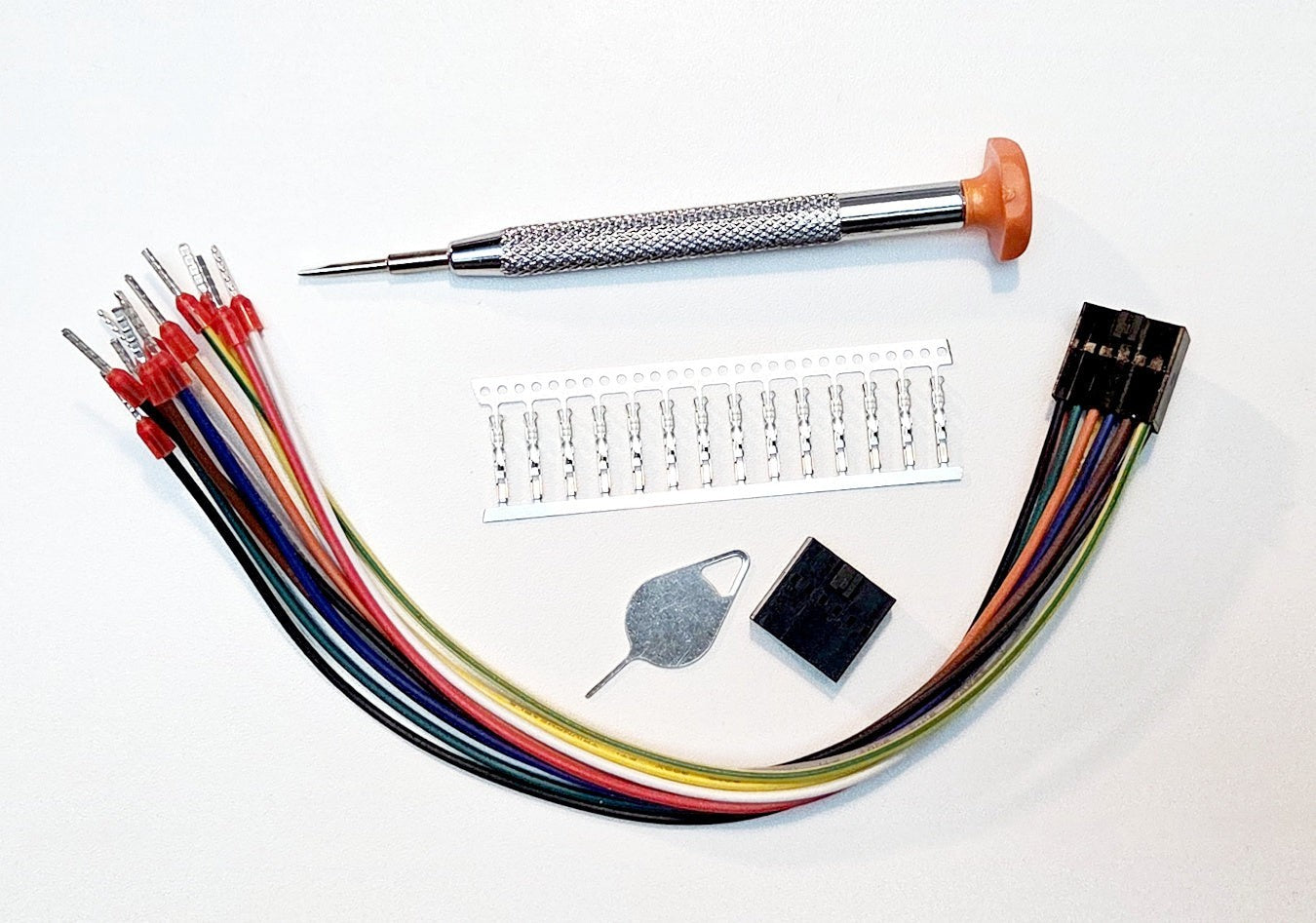 Redispose Stark CMR v2 accessories kit including multi-colored wires, screwdriver, SIM ejector tool, and electronic components.